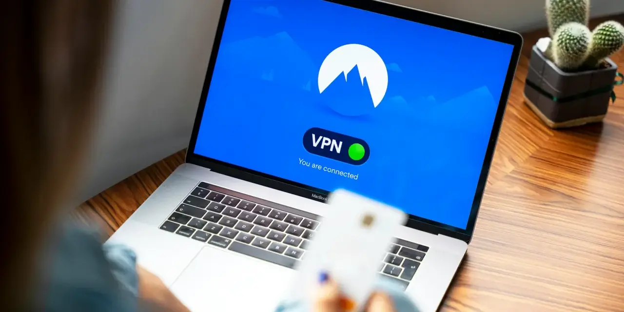 Osoba korzysta z laptopa z włączoną vpn przeglądarką. Na ekranie widnieje logo i komunikat "You are connected".