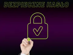Ręka rysuje zieloną kłódkę z zaznaczeniem, symbolizującą silne hasło. Napis "BEZPIECZNE HASŁO" podkreśla znaczenie ochrony danych.