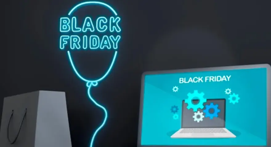 Neonowy balon z napisem "Black Friday" i laptopem. Dowiedz się, jak bezpiecznie kupować w internecie podczas wyprzedaży.